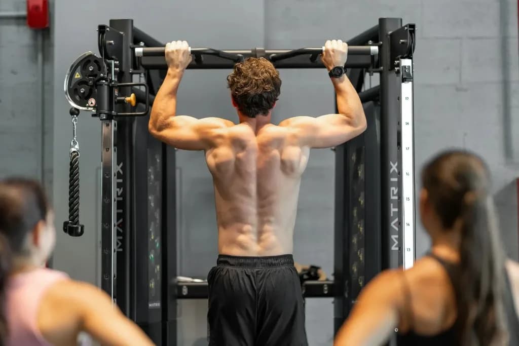 Athlete performing a pull-up during HYROX strength preparation
