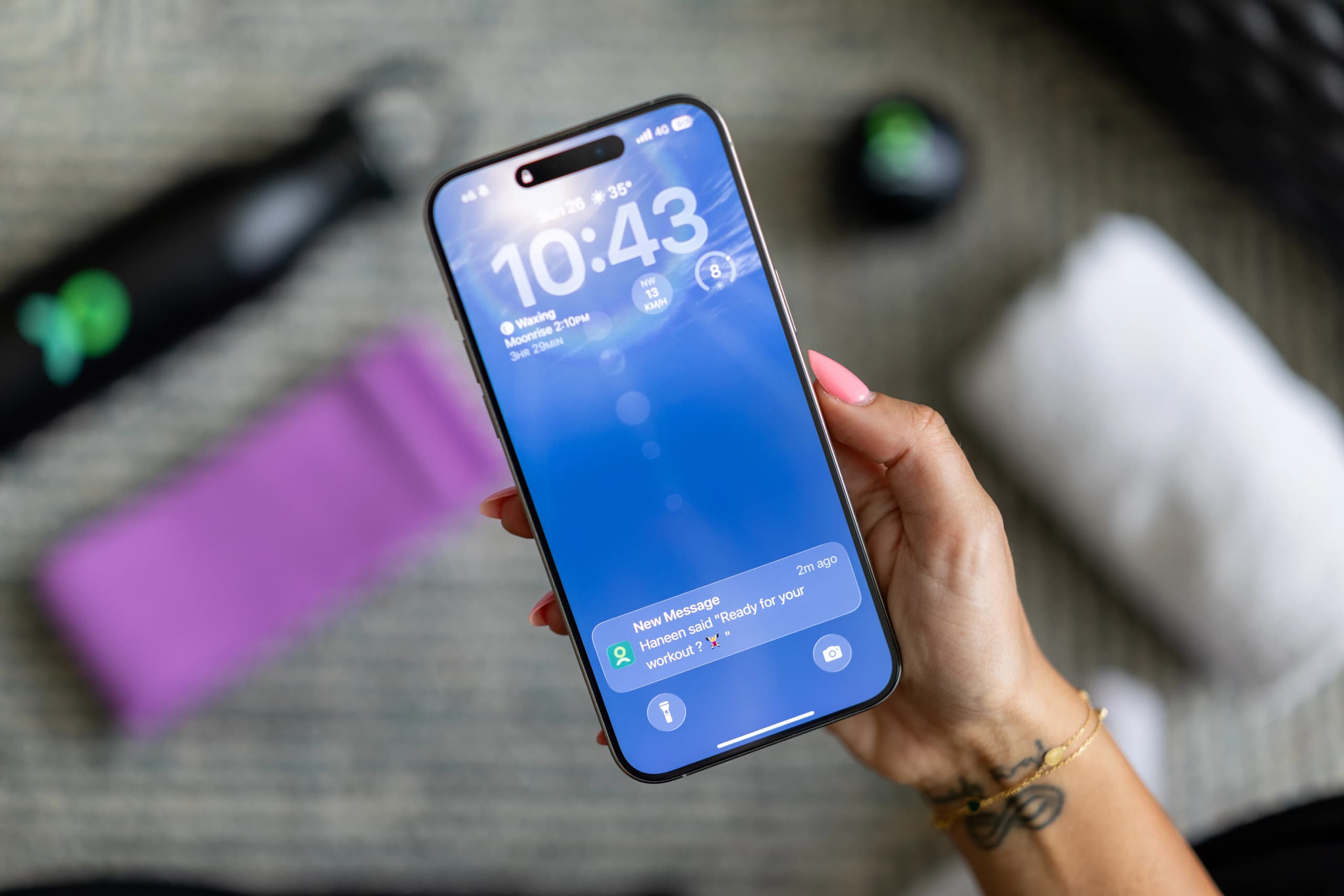 Smartphone displaying fitness reminders and notifications related to workout consistency