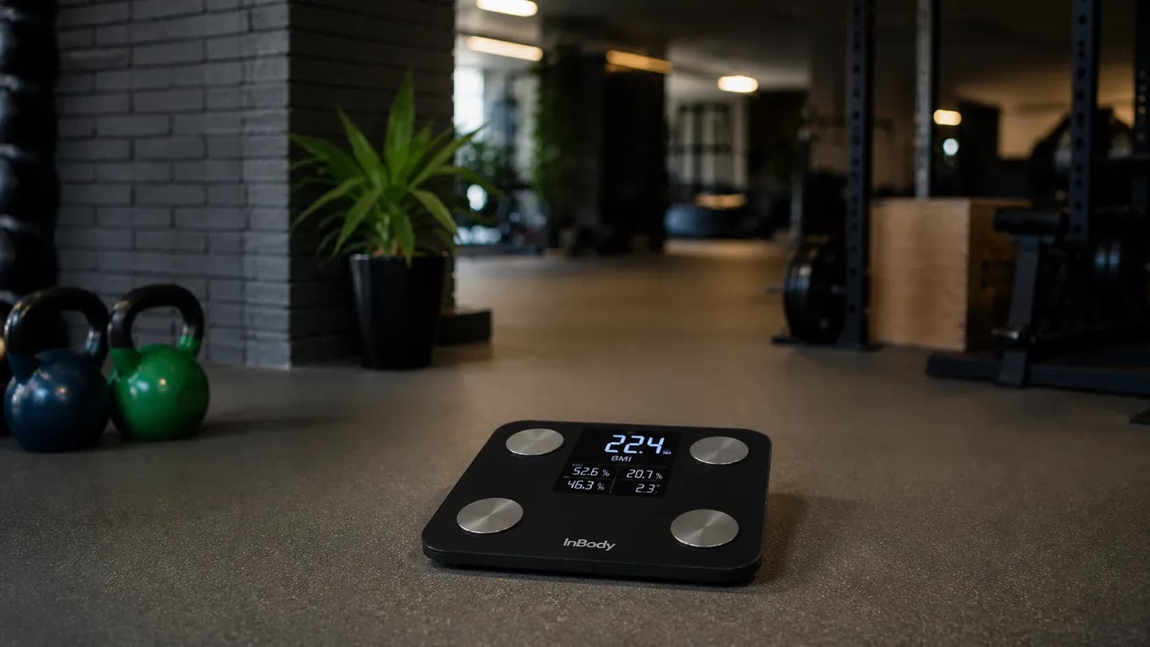 Fitness coach analyzing body composition and BMI using a smart scale in a gym