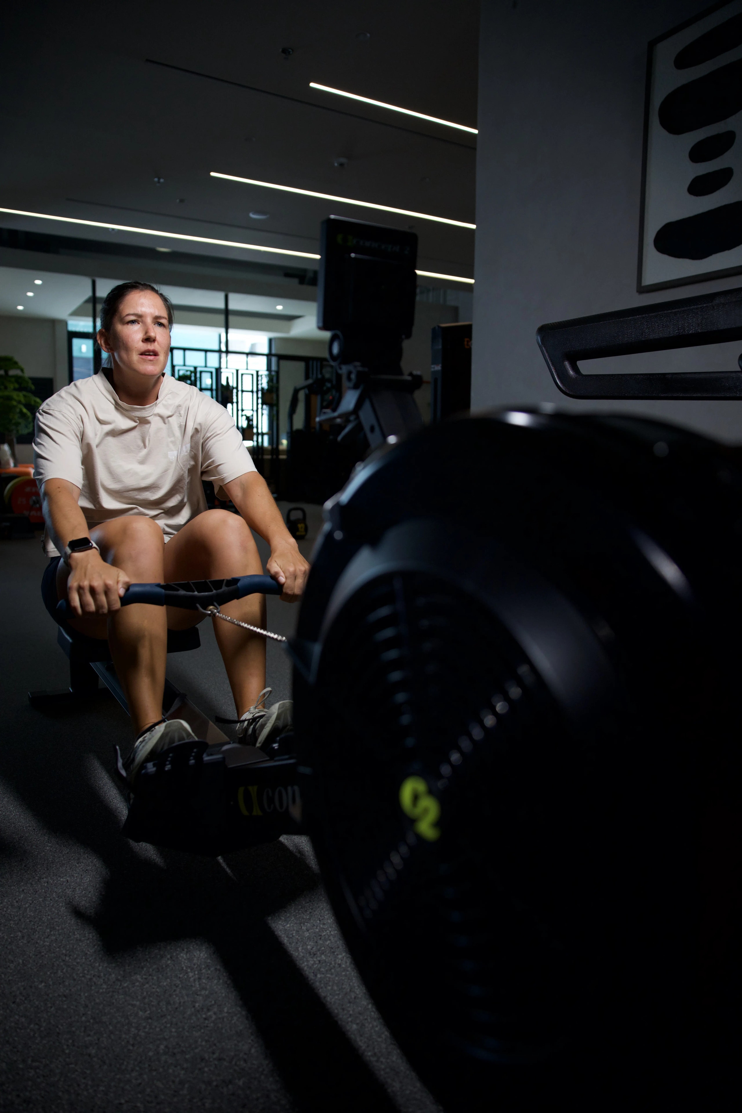 Athlete training on a rowing machine as part of HYROX race preparation.