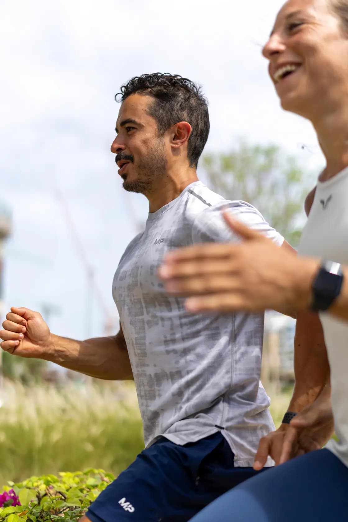 Two everybody clients training in Dubai, smiling and training together, showing the energy and joy of consistent coached fitness.